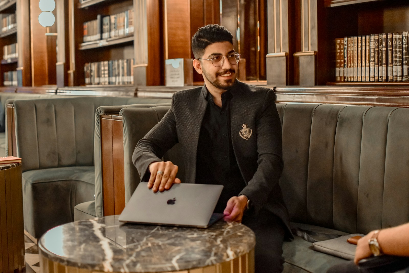 a man sitting at a table with a laptop, agent